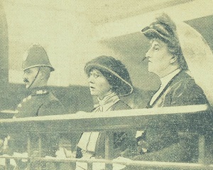 Image of Ethel Moorhead standing with Dorothea Chalmers Smith on her left and a policeman on her right.